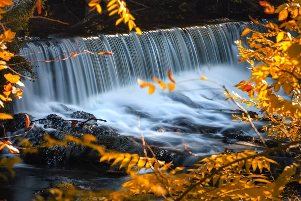 Waterfall framed by fall foliage in Barett Park in Beacon, NY. 