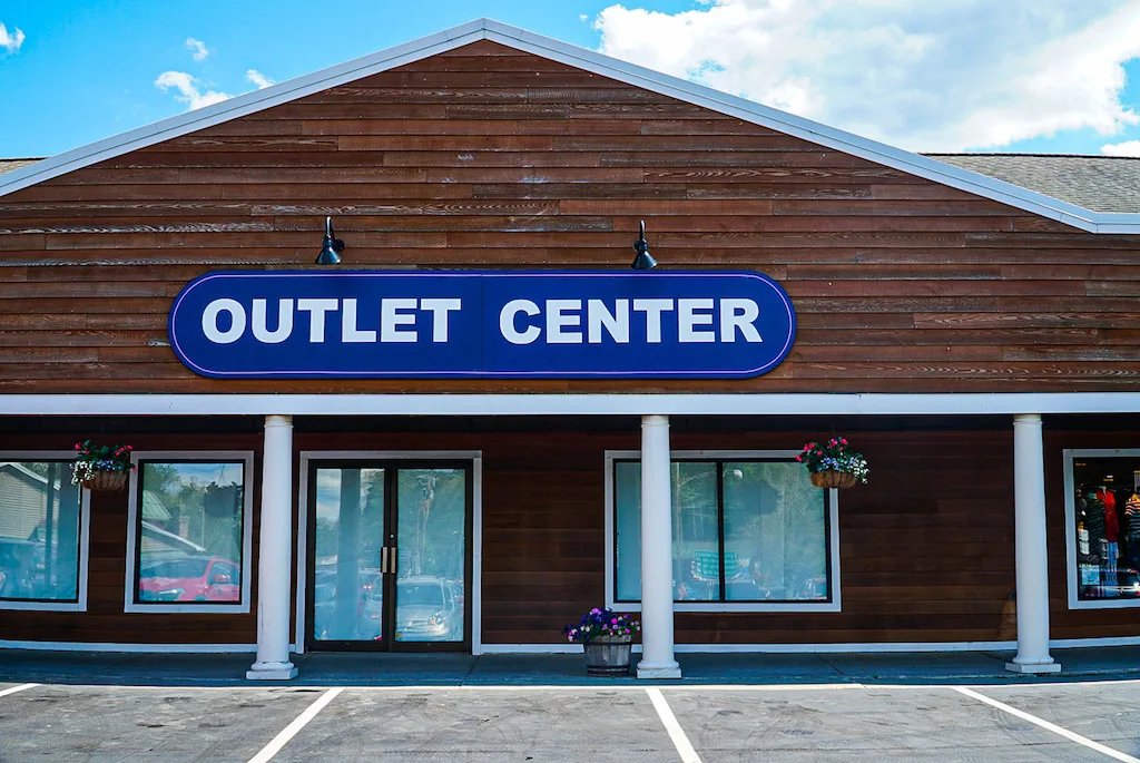 The wooden exterior of the Outlet Malls since shopping is one of the cool things to do in Lake George.