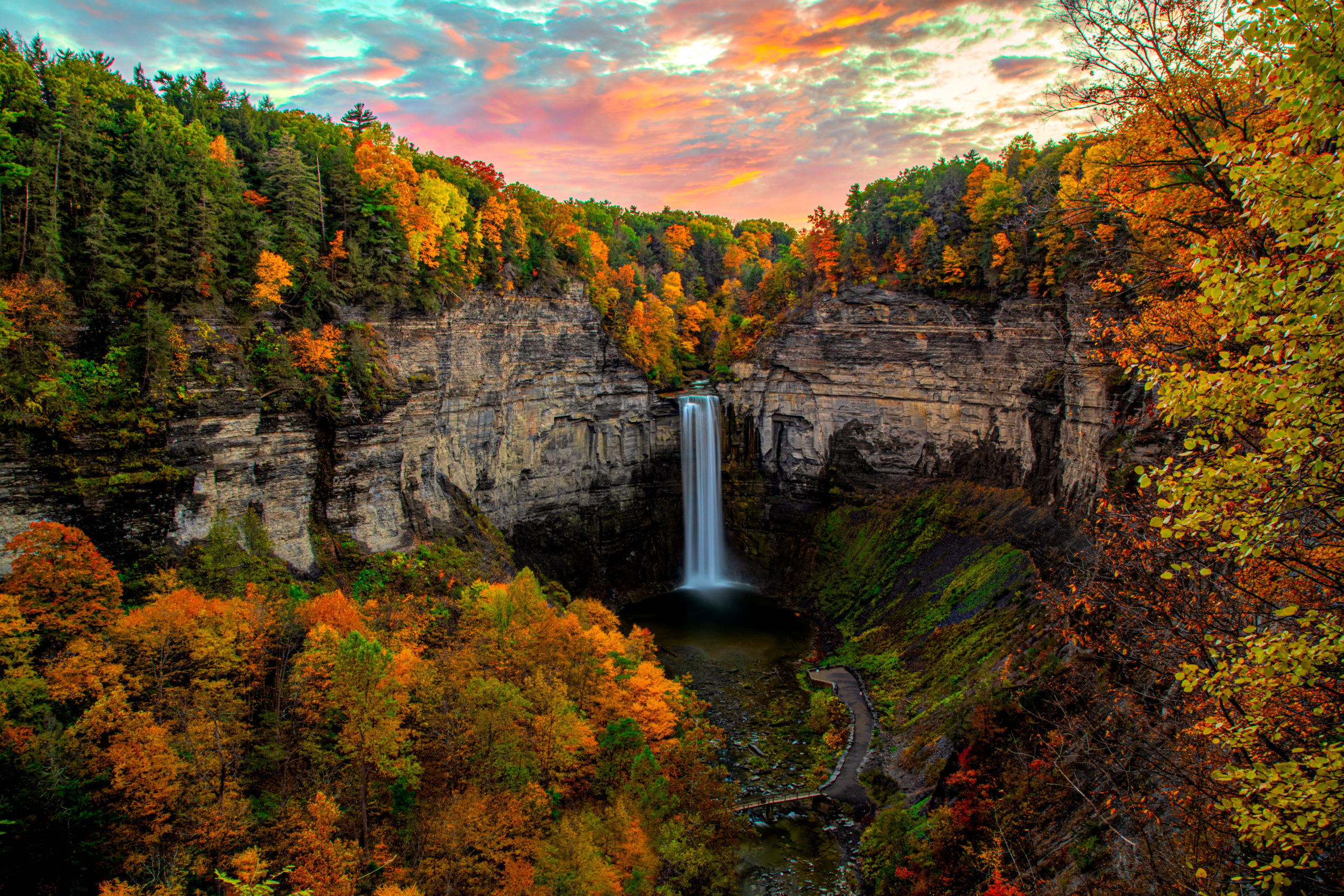 View of Taughannock Falls surrounded by fall foliage in New York, one of the best hikes in Upstate New York.
