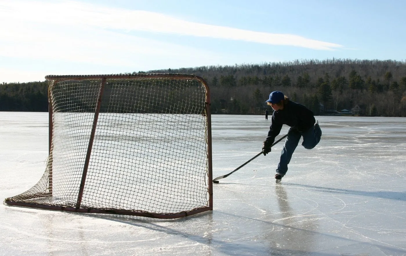 Skater playing hockey on a pond in upstate NY. 