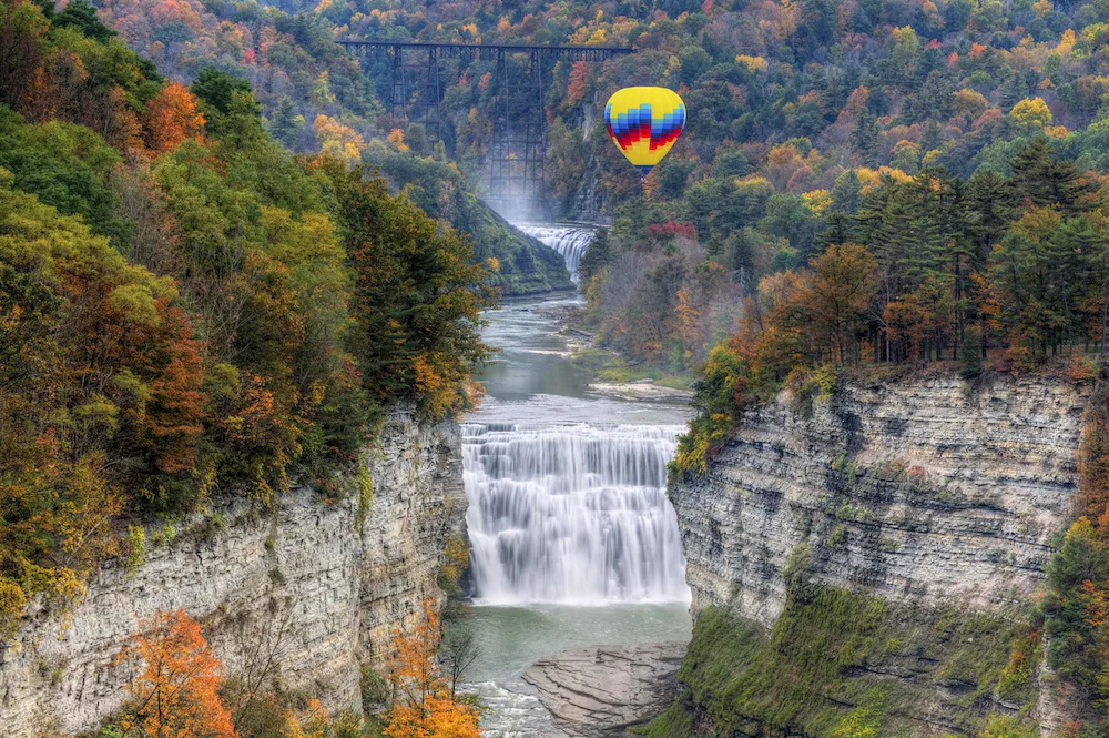 Aerial view of a hot air balloon above the Middle Falls in Letchworth State Park. 
