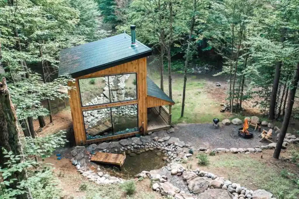 Aerial view of this Luxurious Treehouse with a Cable Bridge and Waterfall and spcaious windows. 