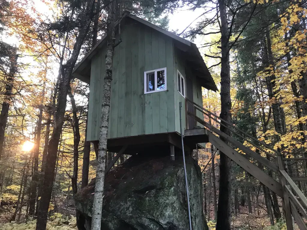 The green exterior of the Rock House in the fall. 