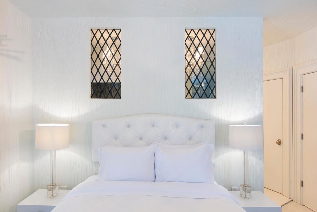 Sleek white room inside the Roxbury Hotel in the Catskills.