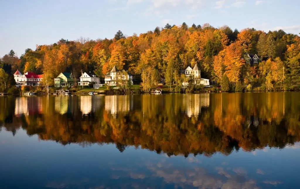 Fall foliage and charming houses on Saranac Lake, one fo the east small towns in Upstate New York