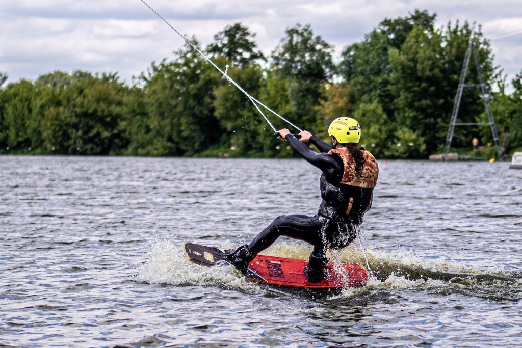 Man wakeboarding and being pulled by a rope. 