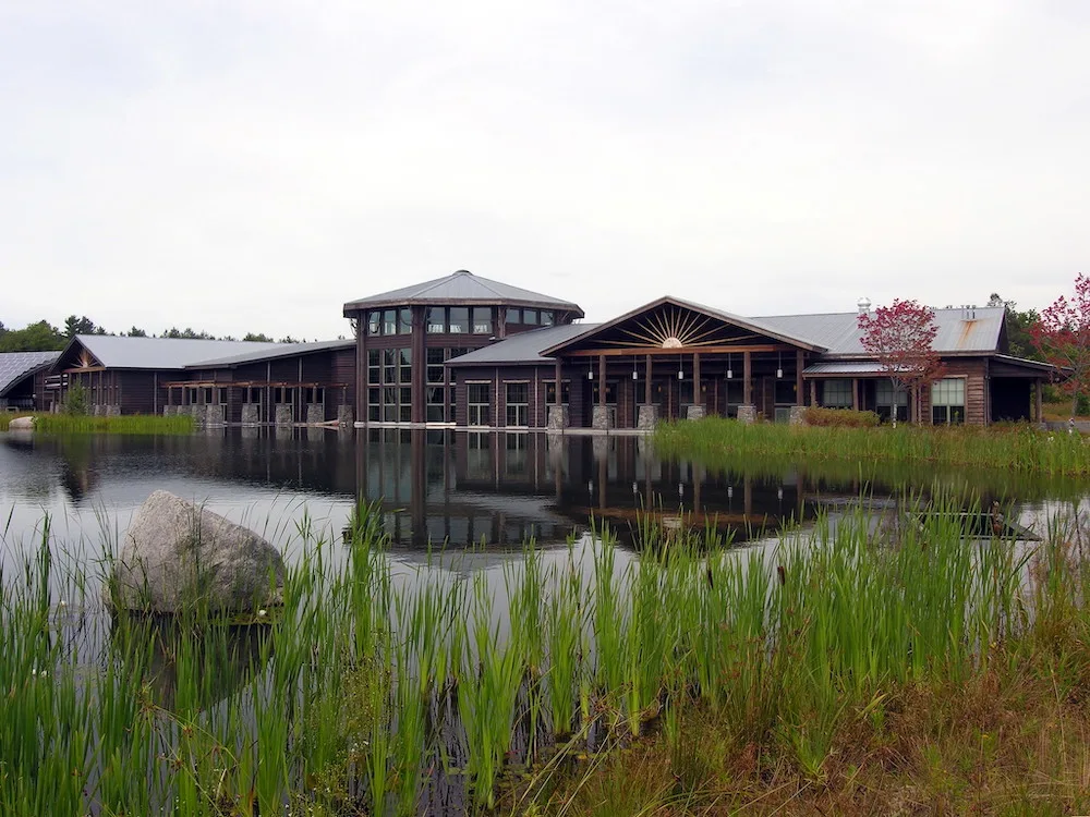 Main building along a pond at the Wild Center in Tupper Lake. 