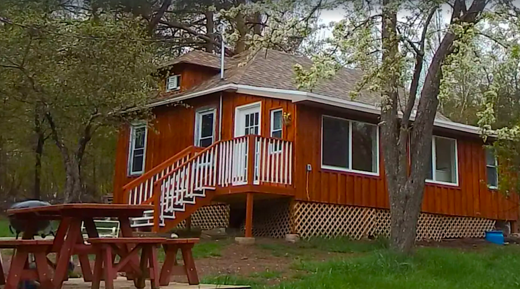 Wood exterior of a cabin in the Hudson Valley with a picnic table outside. 