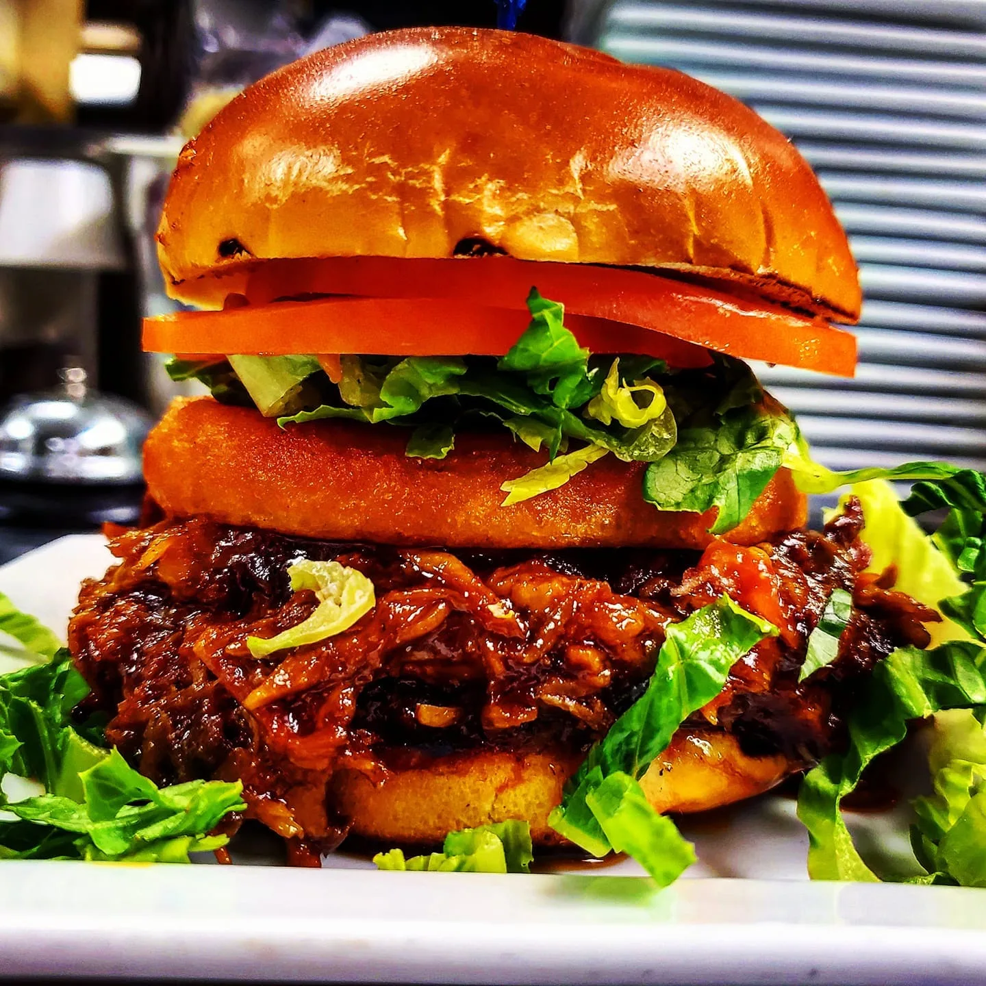 Jameson Pulled Pork Sandwich stacked with lettuce, tomato and all sorts of goodies from the Bridge View Tavern. Catching good food is one of the top things to do in Sleepy Hollow NY