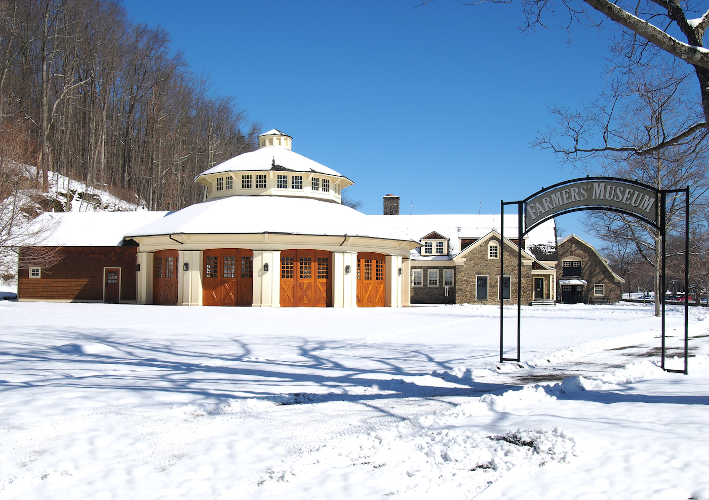 Cooperstown Farmers Museum covered in show and the Empire Carousel. 