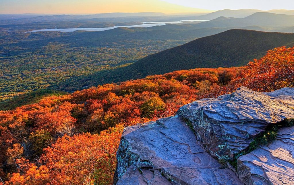 Sunset from the top of Overlook Mountain with fall foliage all around since this is one of the best things to do in Woodstock NY. 