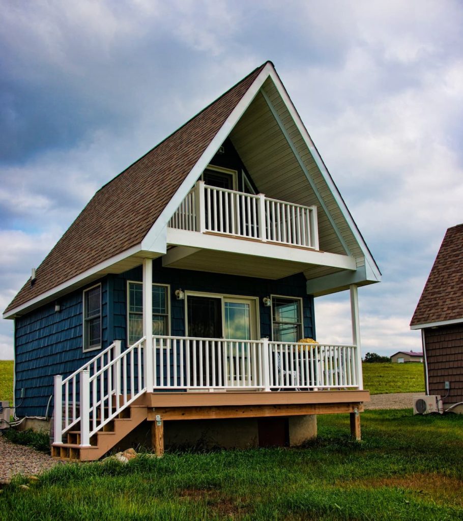 front porch and wood-panneled exterior of this tiny house in the finger lakes. 