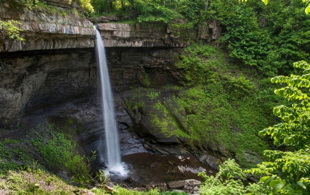 Panoramic view of Carpenter Falls which s surrounded by moss-covered rocks and one of the best waterfalls near Syracuse NY. 