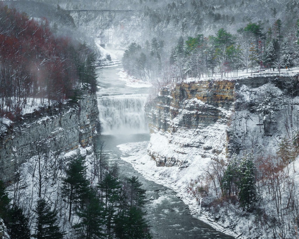 Middle Falls on the Genesee River covered in snow in Letchworth Park. 