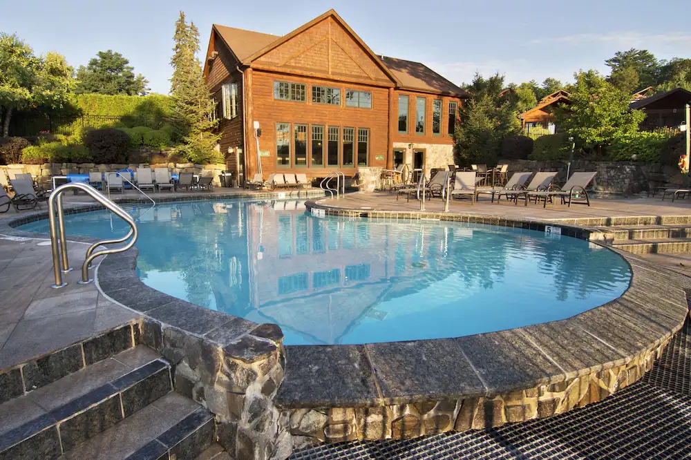 The stunning outdoor pool at The Lodges at Cresthaven in Lake George New York. One of the best romantic getaways in upstate New York. 