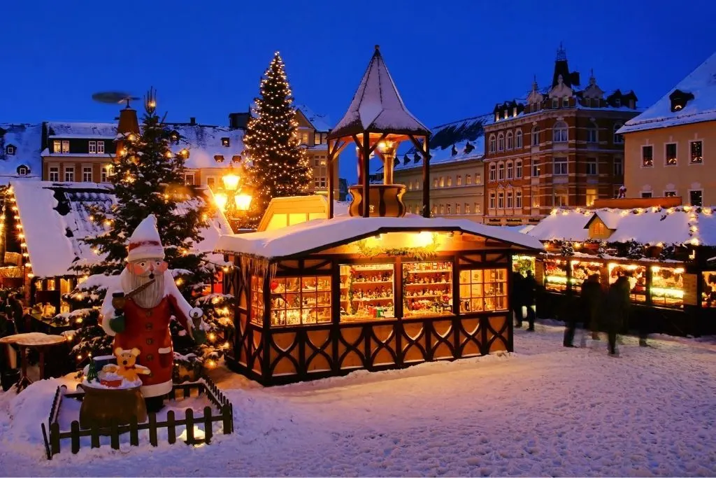 Christmas market covered in snow and one of the best things to do in Lake George in winter. 