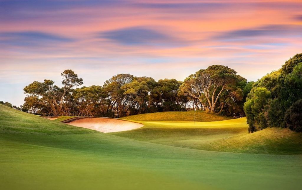 Sunset at the gold course in Saratoga Springs with its green lawns and trees in the background is one of the top things to do in Saratoga Springs NY. 