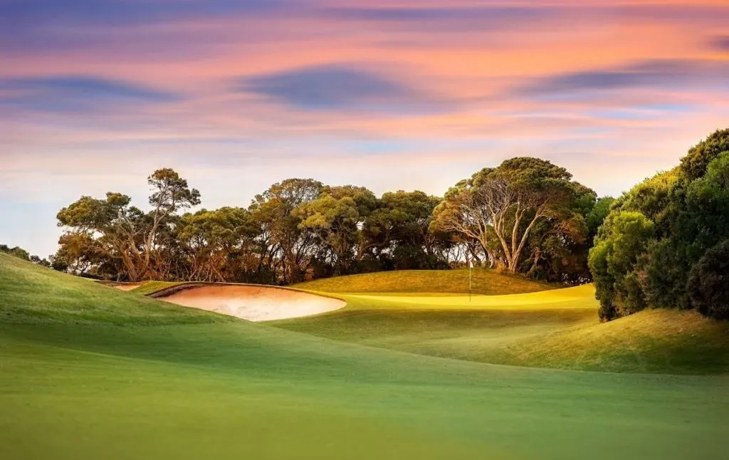 Sunset at the gold course in Saratoga Springs with its green lawns and trees in the background is one of the top things to do in Saratoga Springs NY. 