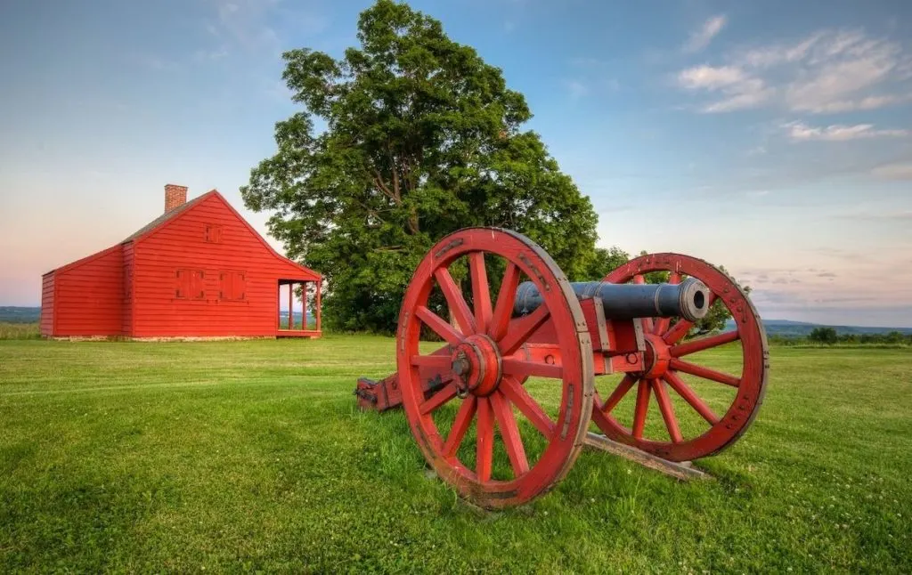 Historic canon in front of the red Nelson Farm at Saratoga National Historical Park. Another great place to visit when visiting Saratoga springs