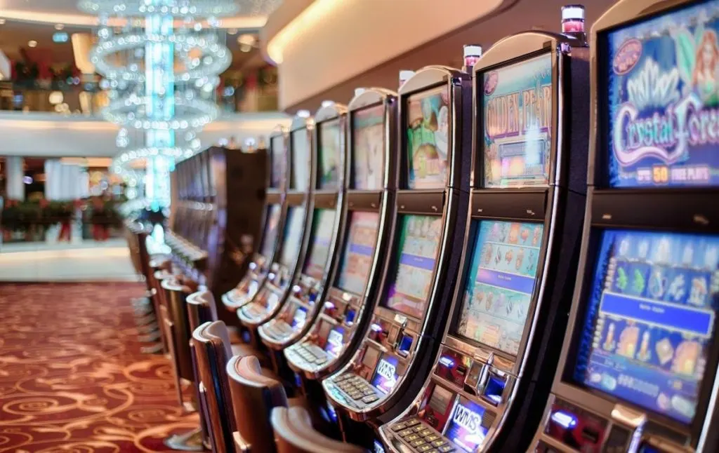 Slot machines at a casino with the opulent decor in the background remains one of the fun things to do in Saratoga Springs 