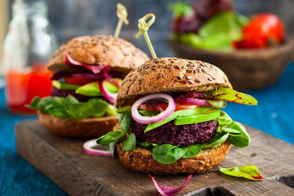 Delicious veggie burger sliders on a wooden cutting board on a table from Brazil Craft Beer and Wine Lounge. 