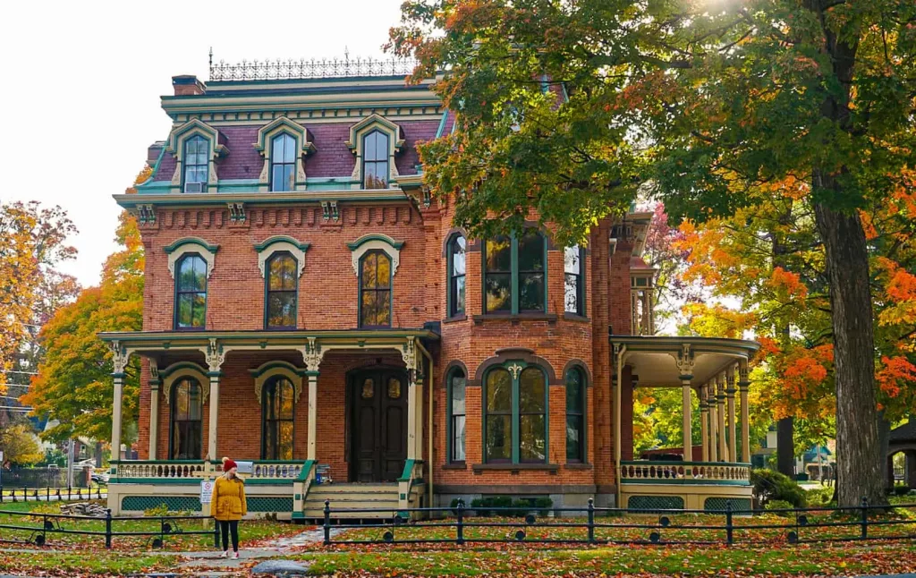 A view of me standing in front of a historic brick home in saratoga Springs.