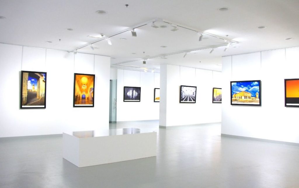 White walls, open spaces, and vibrant art inside a modern art gallery. 