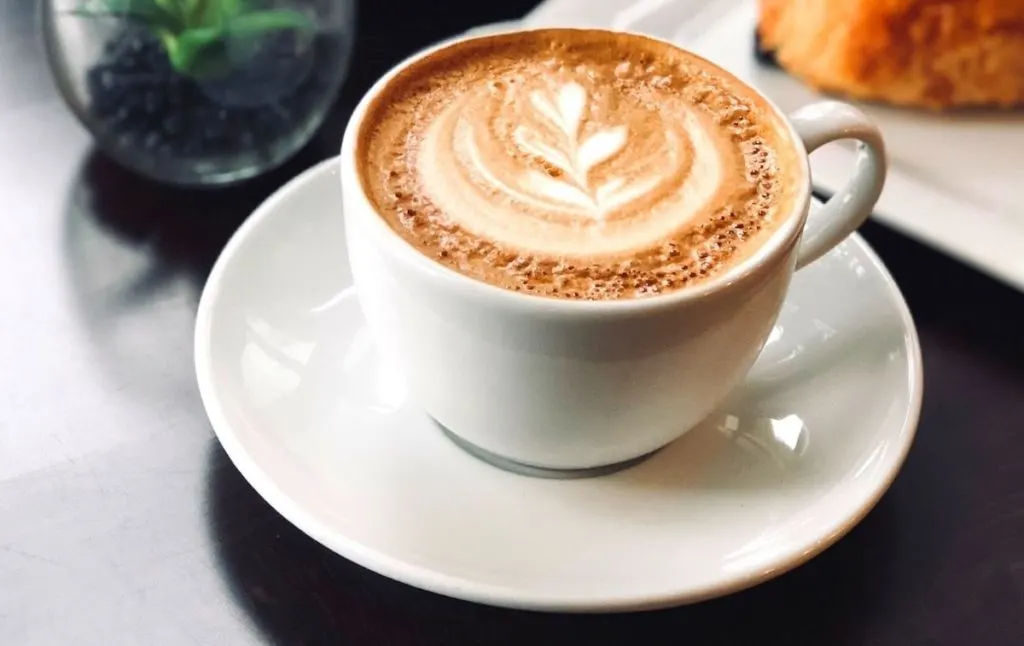 Fresh latte on a black countertop. Coffee shops in Ithaca are really amazing.