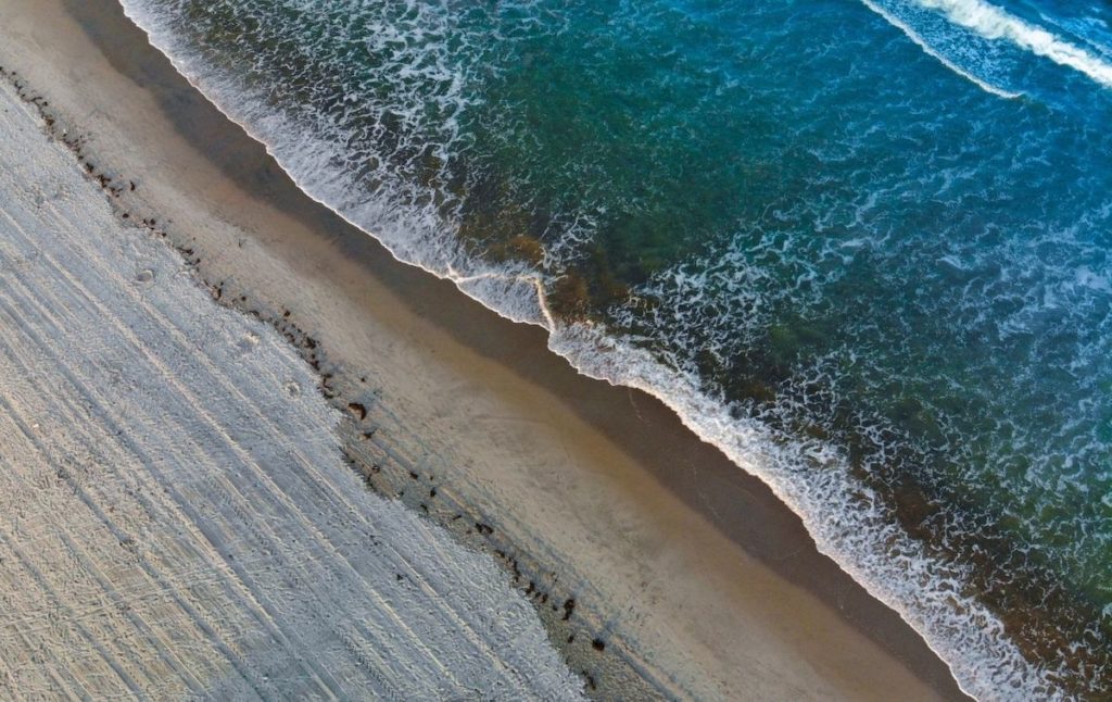 Aerial view of a beach, one fo the top things to do in the Hamptons.