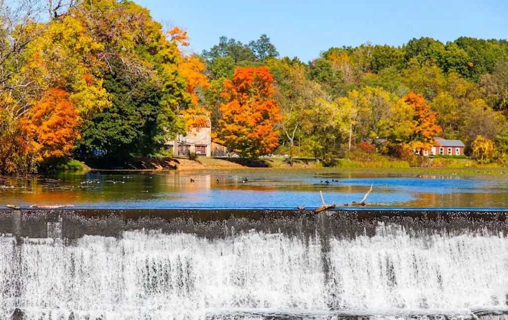 Fall foliage in the Hudson Valley and a scenic waterfall at one of the best yoga retreats in New York. 