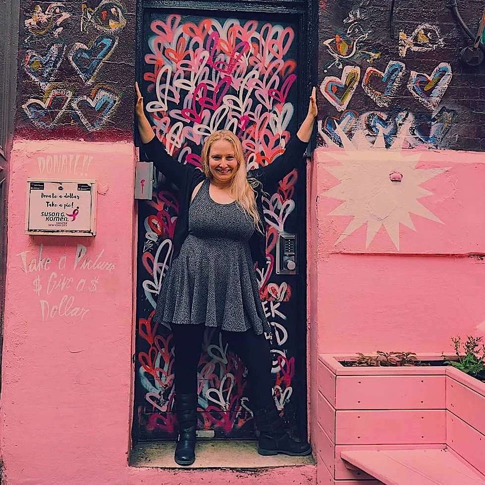 Me standing out front of the pink-hued exterior of Pietro Nolita restaurant which is another fun and unusual restaurant in NYC