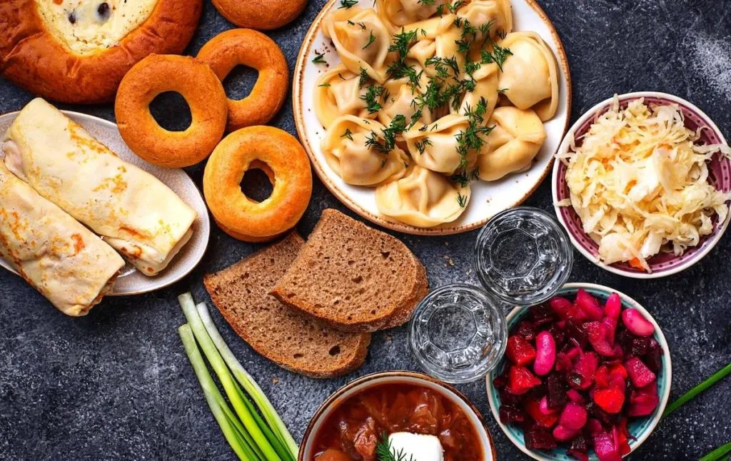 Aerial view of traditional Russian food which includes dumplings, bread, wraps, cabbage and more at one of the most quirky restaurants in NYC. 