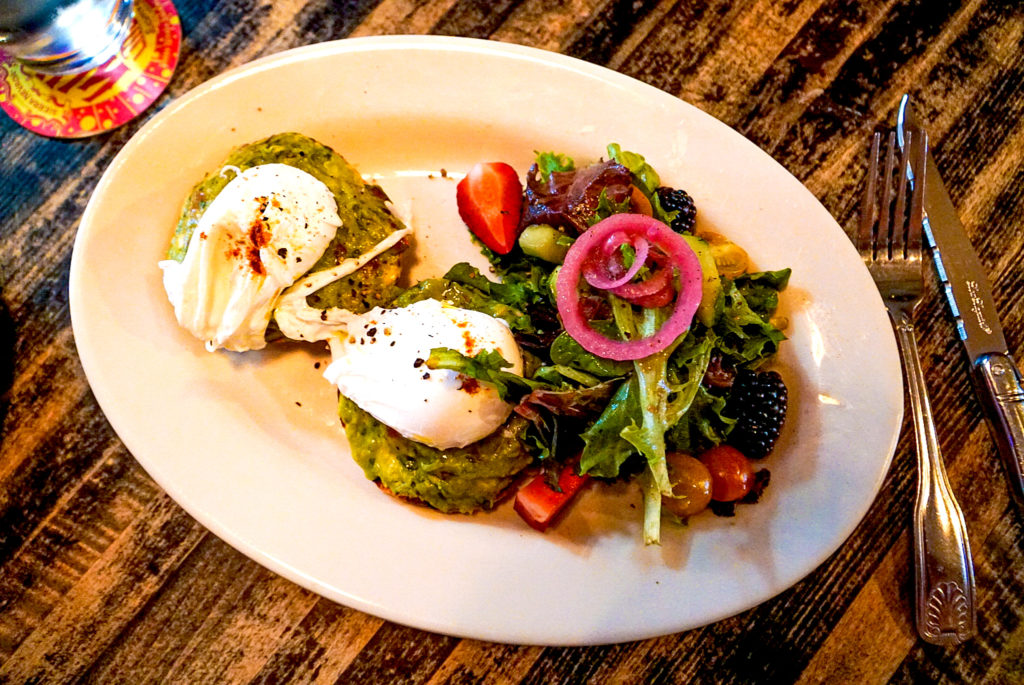 Avocado toast with poached egg on top at one of the best cafes in the area and eating here is definitely one of the top things to do in Woodstock NY. 