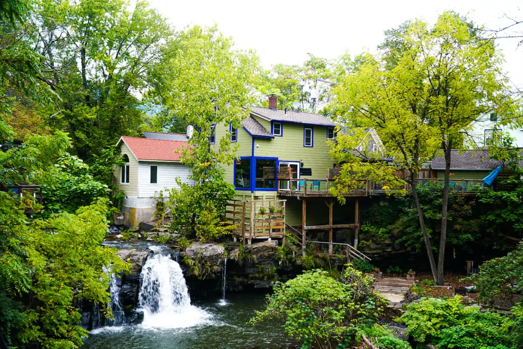 A mini waterfall at the side of a wooden green house gives the feeling of peace and quiet which is definitely one of the reasons why people explore the things to do in Woodstock NY.