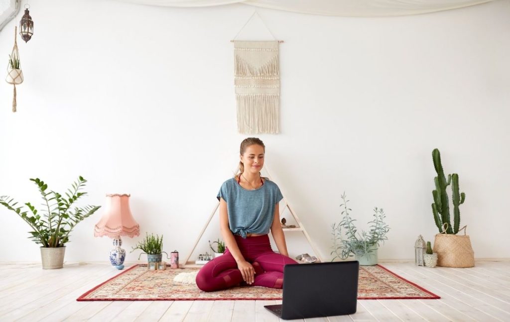 Woman sitting in a yoga studio at one of the best yoga retreats in New York. 