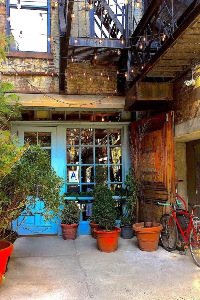 The charming turquoise exterior of Freemans, a cute brunch places NYC. 