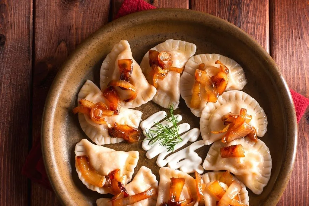 Pierogis in a wooden bowl on a wooden table at one of a fun brunch NYC has. 