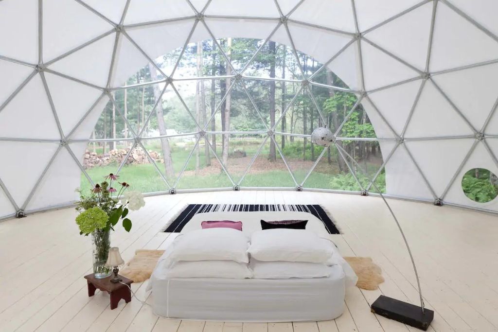 The bright white interior of the geometric dome at the Outlier Inn, home to some of the best glamping in New York. 