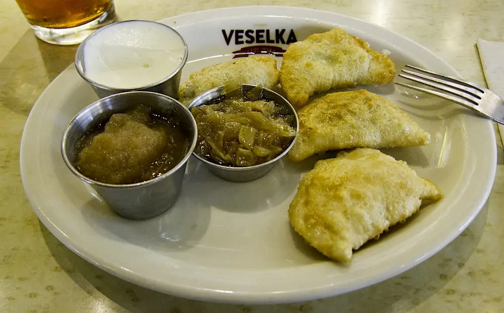 View of a plate of pierogis and sauces from Veselka. 