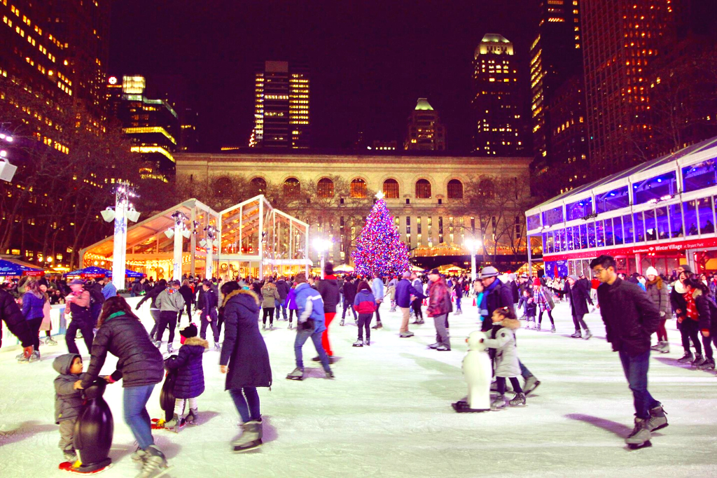 Ice skaters at the winter village in Bryant Park during Christmas in New York City.