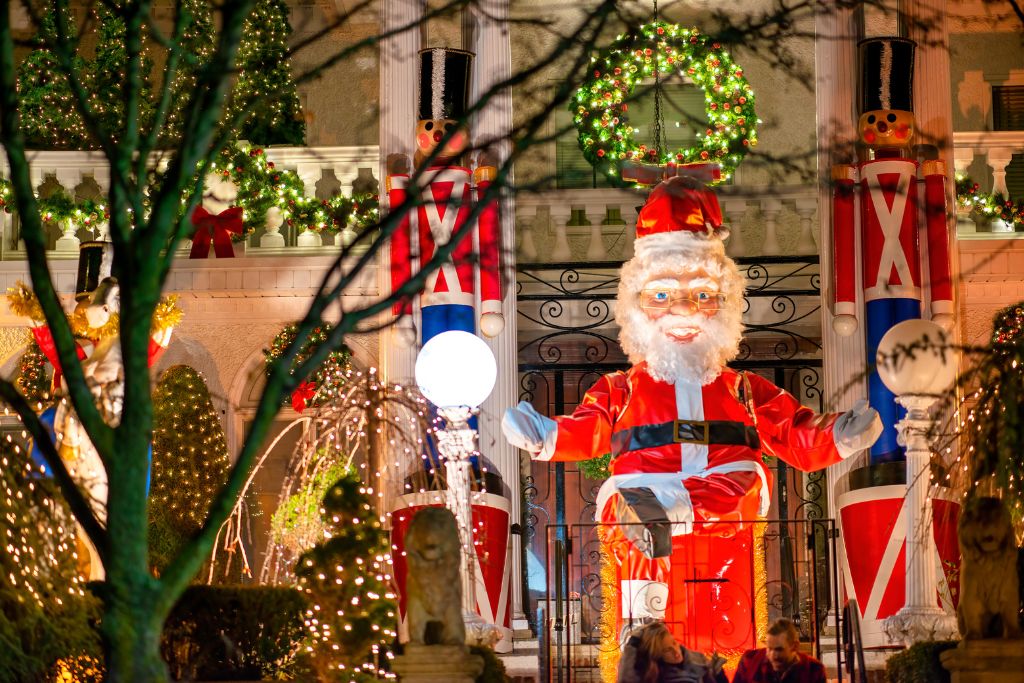 The vibrant Christmas lights in Dyker Heights with a blow up Santa. One of the best things to do in Christmas in New York City.