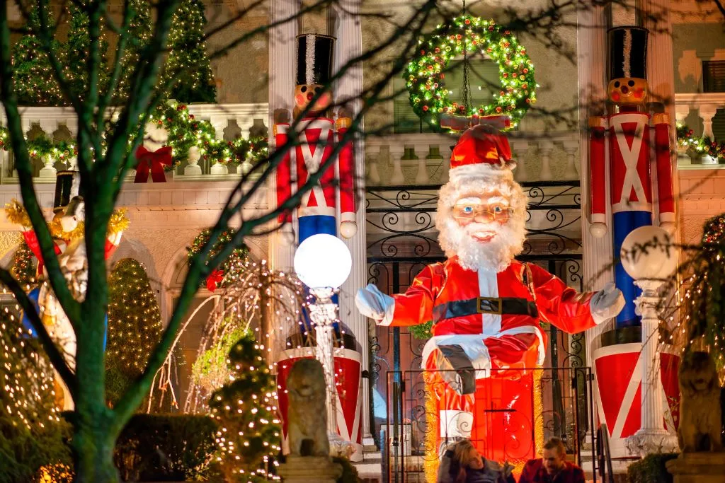 The vibrant Christmas lights in Dyker Heights with a blow up Santa. One of the best things to do in Christmas in New York City. 