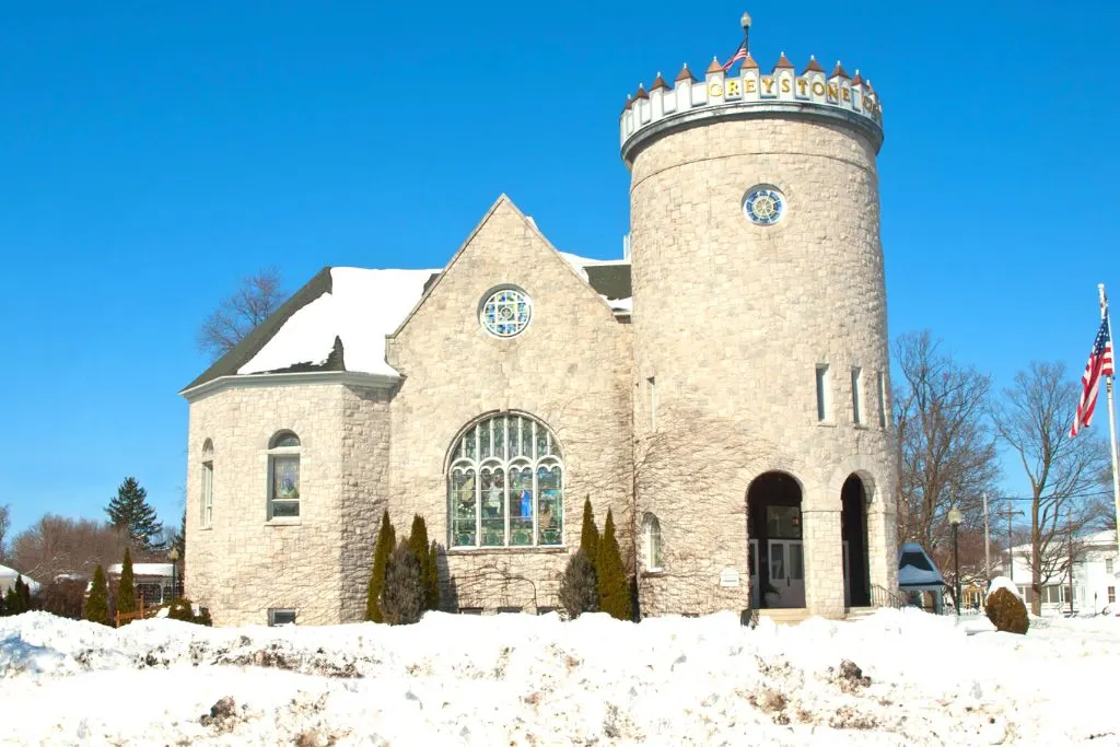 Greystone Castle in Canastota, Ny has a stunning, brick exterior covered in snow. 