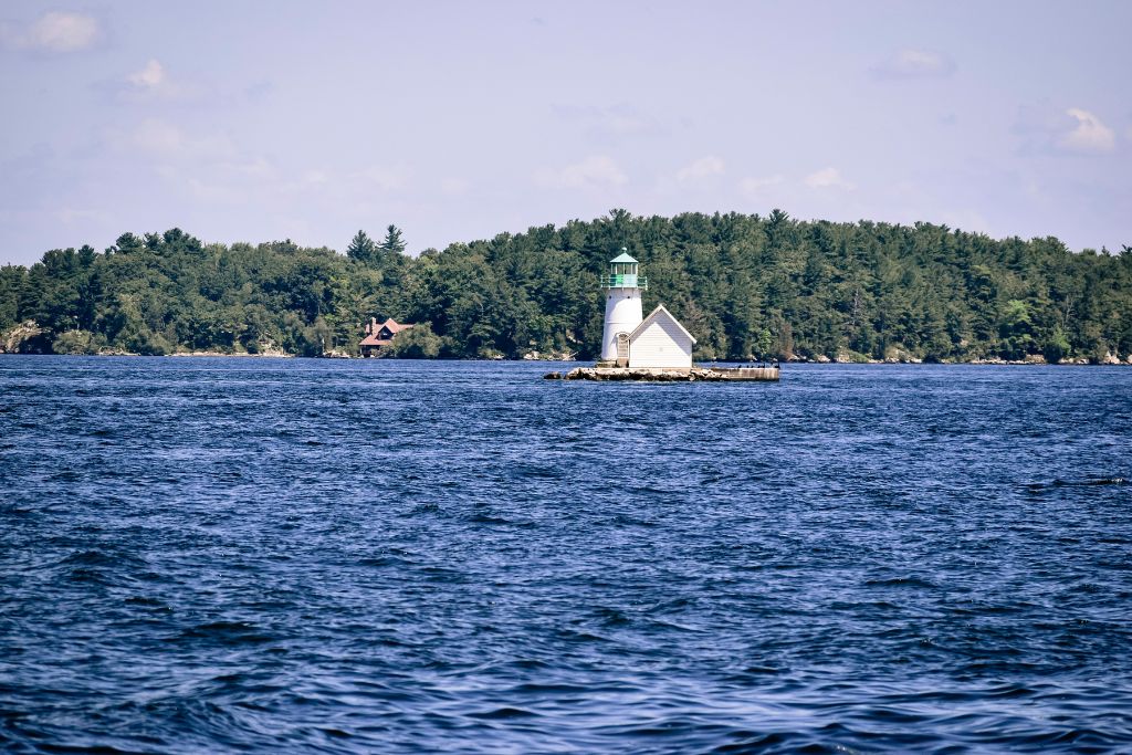 View of the waters around Alexandria Bay with a sail baot curising past. 