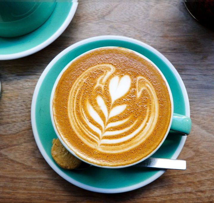 Aerial view of coffee in a turquoise cup.