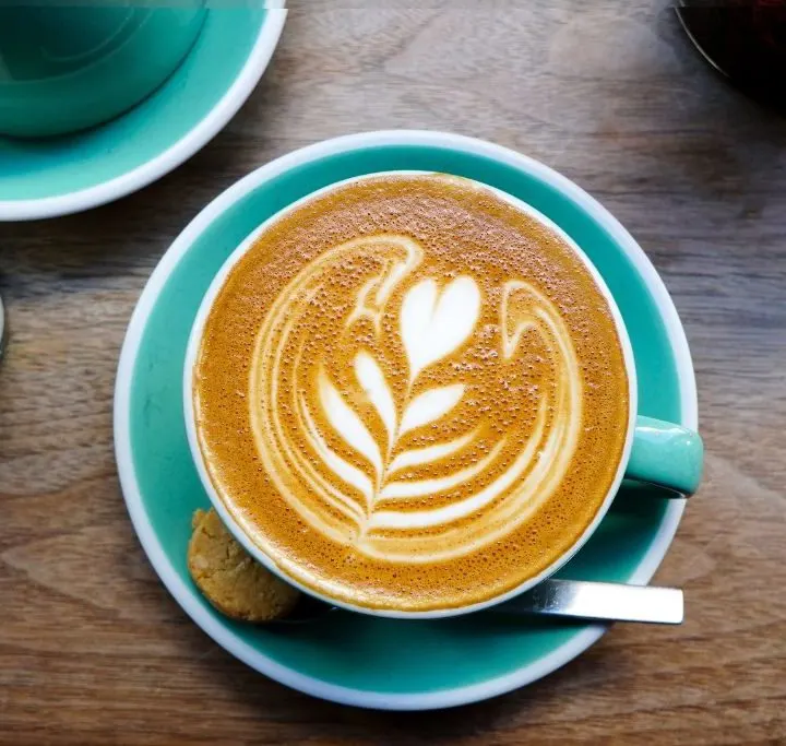 Aerial view of coffee in a turquoise cup.