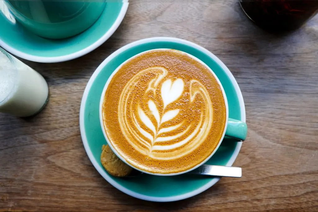 Aerial view of coffee in a turquoise cup. 