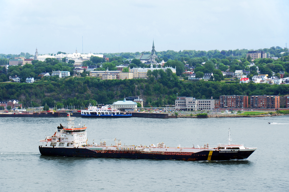 View of a boat cruising down the St. Lawrence River. 