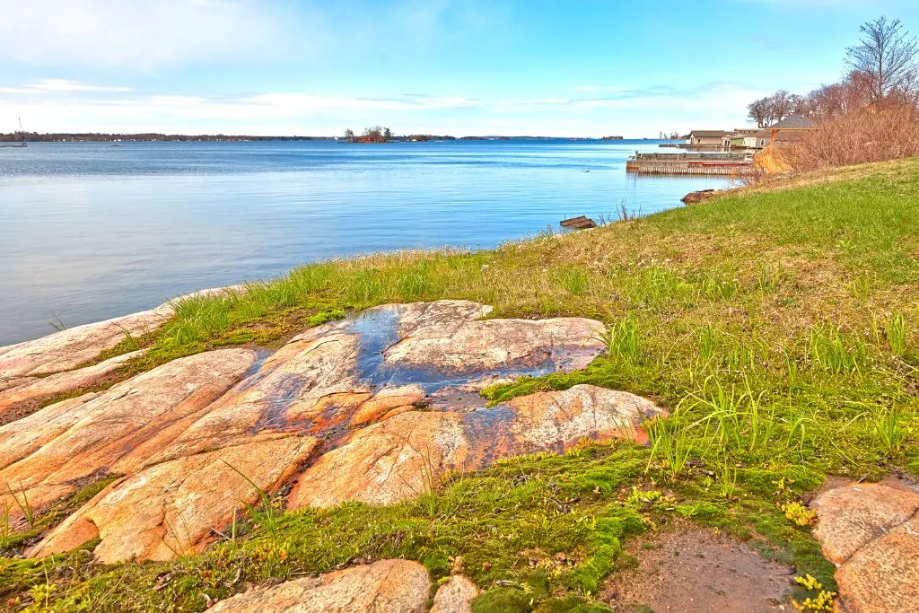 Beautiful coastal scenery on Wellesley Island in the Thousand Island regions with the river along the green shores. A must see during your Alexandria Bay  NY itinerary. 