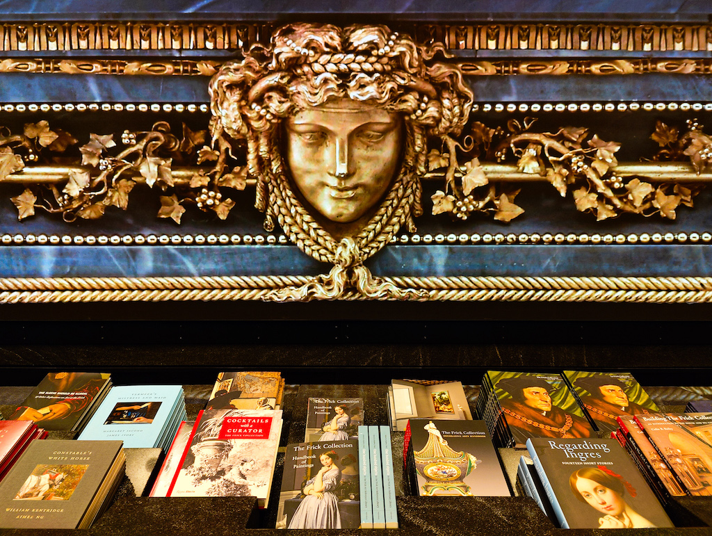 Books in display and an electronic Renaissance art display at the Frick Collection. 